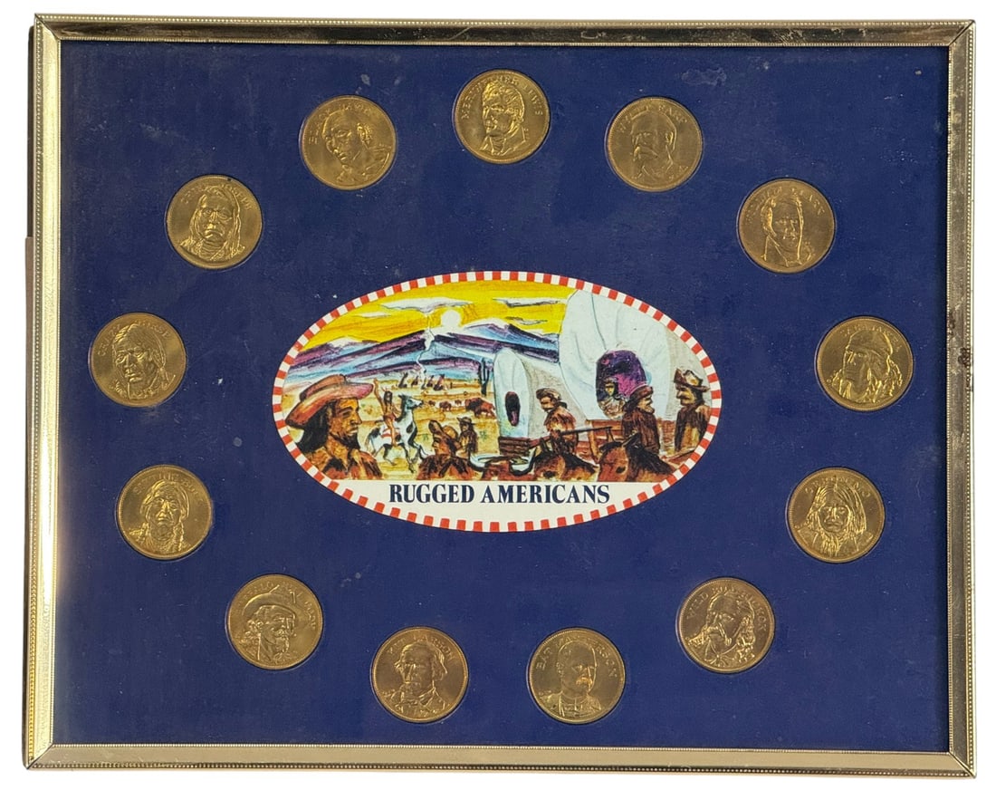 'Rugged Americans' Framed Commemorative Coin Set: This framed coin set titled Rugged Americans celebrates iconic figures from American frontier and indigenous history. Arranged in a circular formation around a colorful central illustration of a