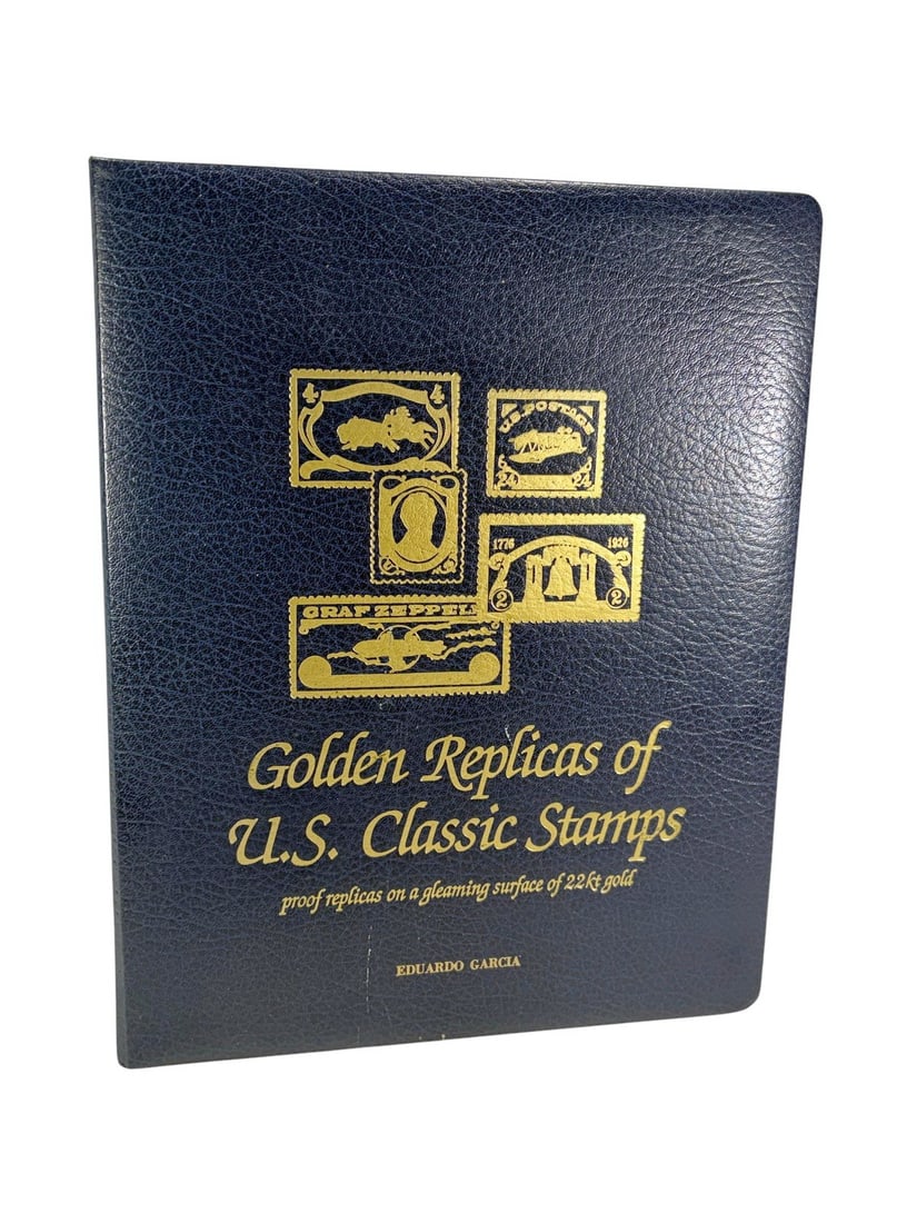Golden Replicas of U.S. Classic Stamps 1847-1932: Postal Commemorative Society 'Golden Replicas of U.S. Classic Stamps' album featuring 22 karat gold stamp replicas mounted on informational cards, in a navy hardbound volume with name on