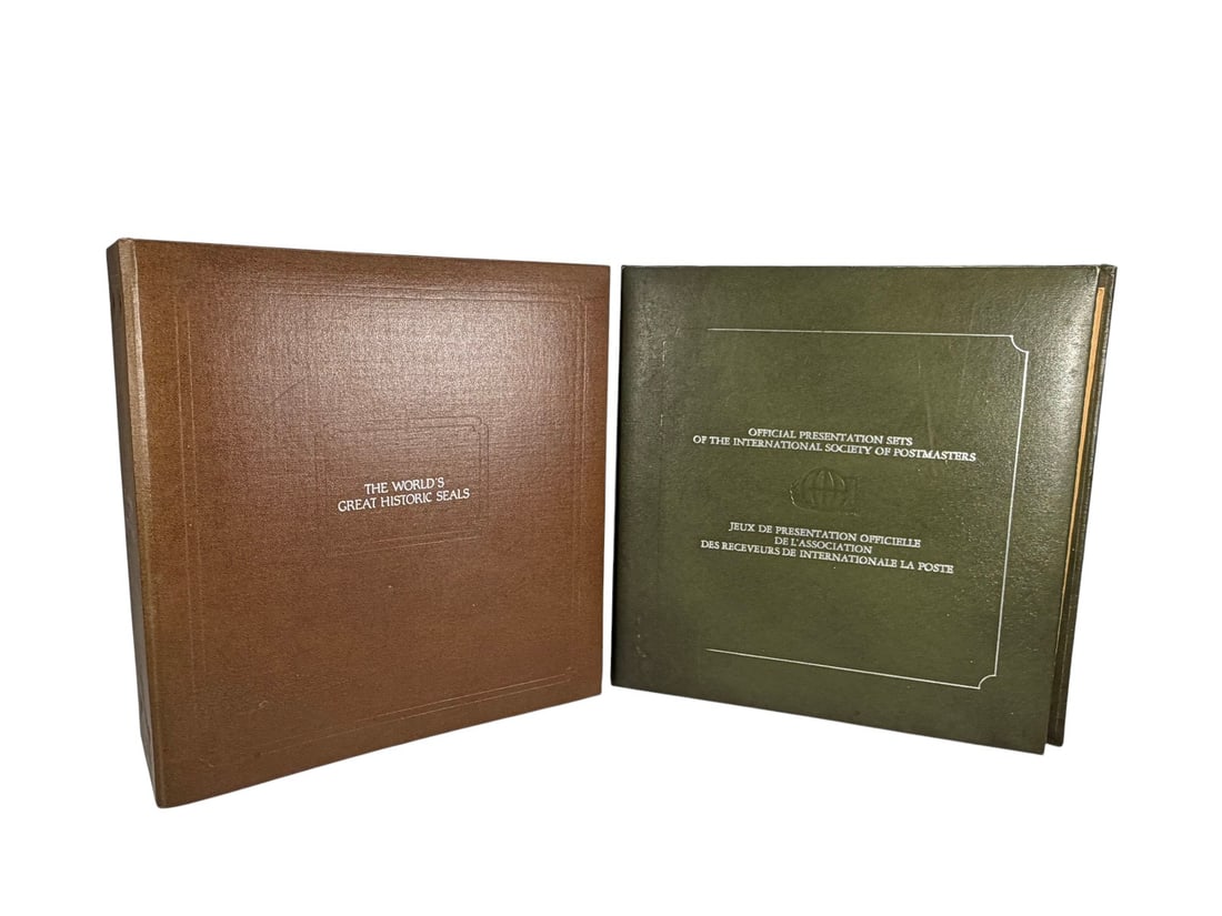 The World's Great Historic Seal Albums 2pc LOT: Two-piece collector's lot including 'The World's Great Historic Seals' folio with seal engravings and medallion replicas, and an International Society of Postmasters album with commemorative stamp