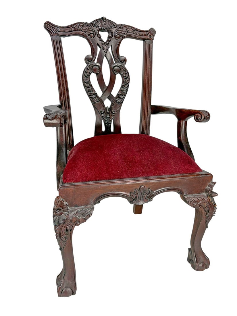 Chippendale Style Red Mahogany Miniature Armchair: Miniature Chippendale-style carved mahogany armchair with scrollwork detailing, cabriole legs with claw feet, and red velvet upholstered seat.Dimensions: 20 X 12.75 X 11.25 in. Condition: Good ove