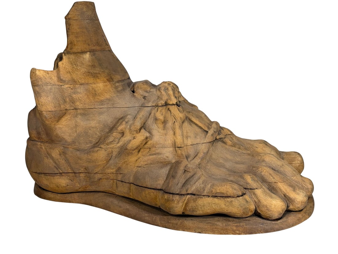 Large Carved Wood Foot of Hermes Sculpture: Large carved wooden sculpture of a stylized foot, with carved anatomical details, a partially hollowed interior, and an integral base.Dimensions: 12.75 X 18.75 X 8 in. Condition: Good overall cond