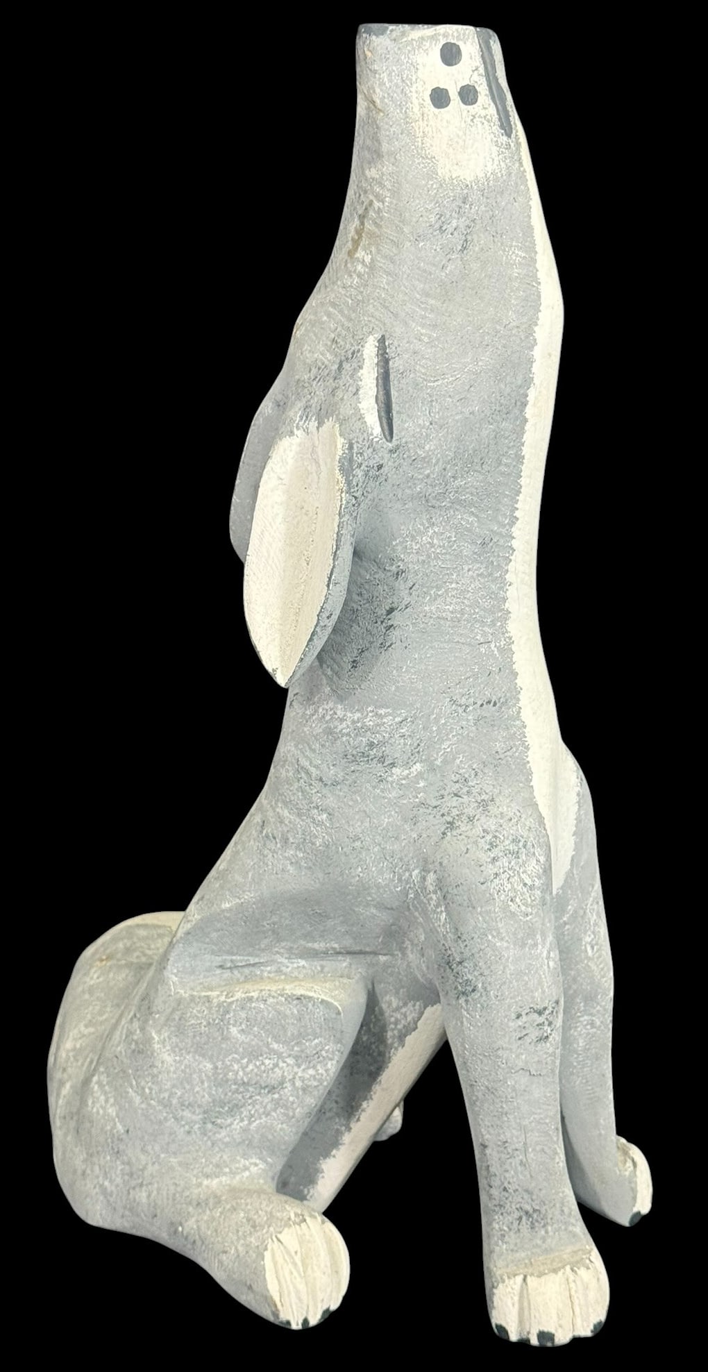 Joe Ortega Folk Art Painted Wood Coyote Carving: Joseph Ortega (American, 20th/21st century) hand-carved and painted wooden sculpture of a coyote, sitting with its head tilted upward in a classic howling pose. Painted in tones of gray and white