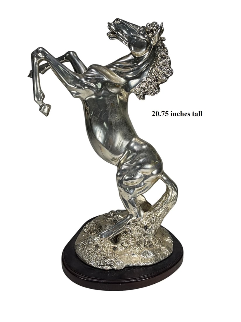 Rearing Horse Silver Electroplated Resin Sculpture: Contemporary silver-tone resin sculpture of a rearing stallion with detailed mane and musculature, mounted on a shaped wood base.Dimensions: 20.75 X 16.25 X 11 in. Condition: Good overall condition