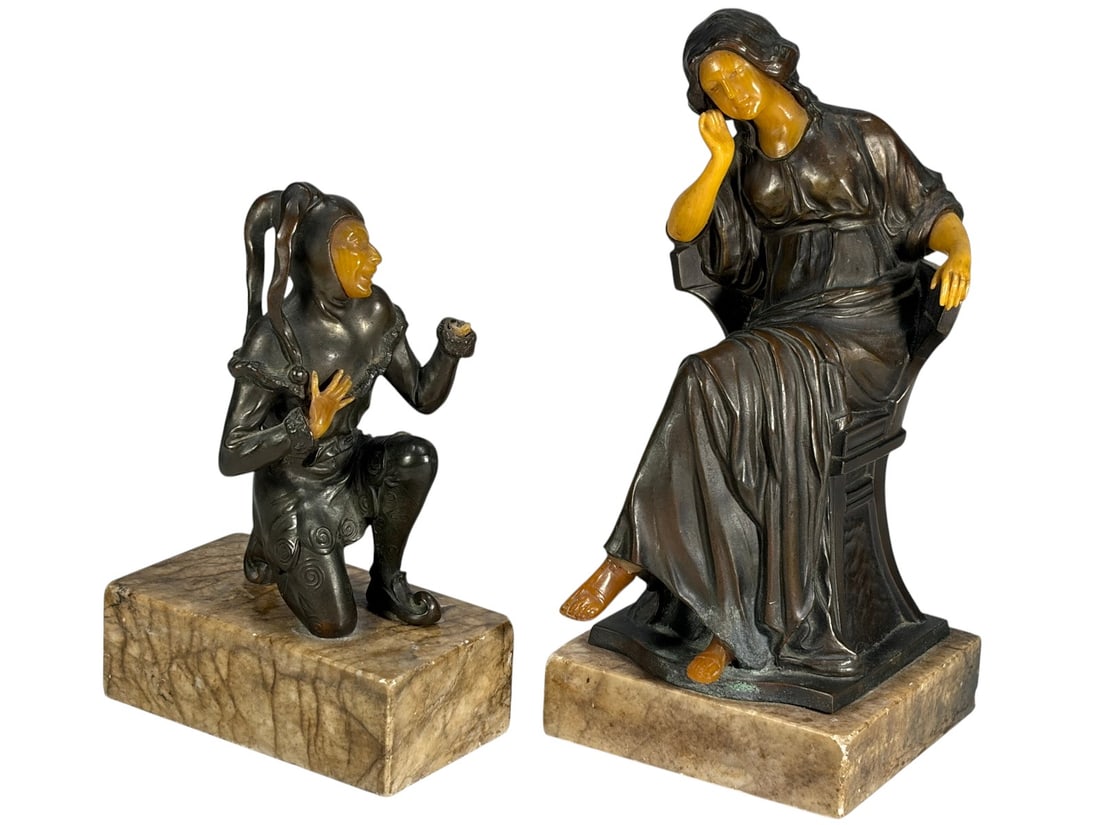 Art Deco Style Jester & Woman Spelter Statues 2pcs: Art Deco style figural spelter sculpture duo, including a seated woman and a kneeling jester, in bronze-tone finish with ivory-colored accents, each mounted on a polished marble base. The largest