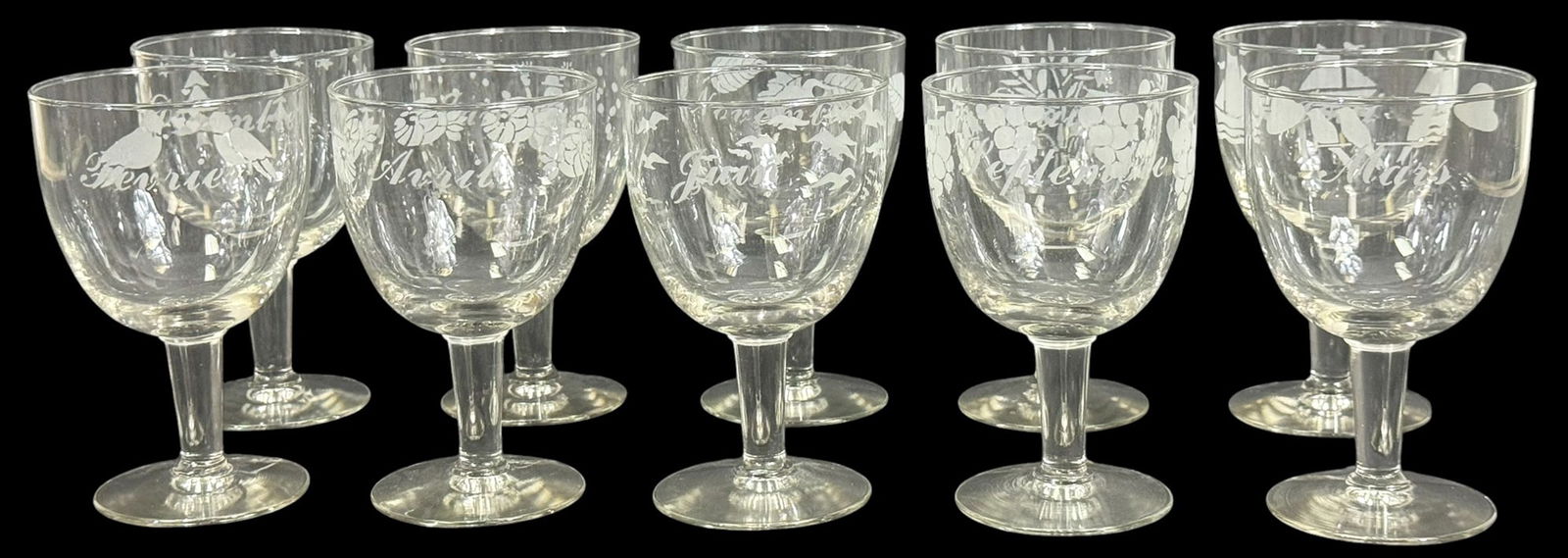 Monthly Etched Crystal Wine Glasses 10pc SET: Set of ten crystal wine glasses, each etched with a unique design representing a different month with a corresponding seasonal motif. The glasses feature delicate frosted imagery such as flowers,