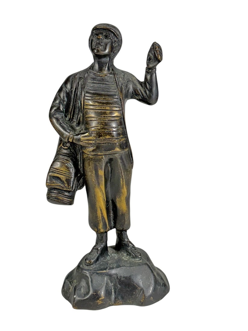 Vintage Golf Caddie Bronze Sculpture 9.75": Vintage bronze sculpture of a young golf caddie with raised arm and golf bag over shoulder, in dark patina on a textured base.Dimensions: 9.75 X 4.75 X 3.25 in. Condition: Good overall condition w