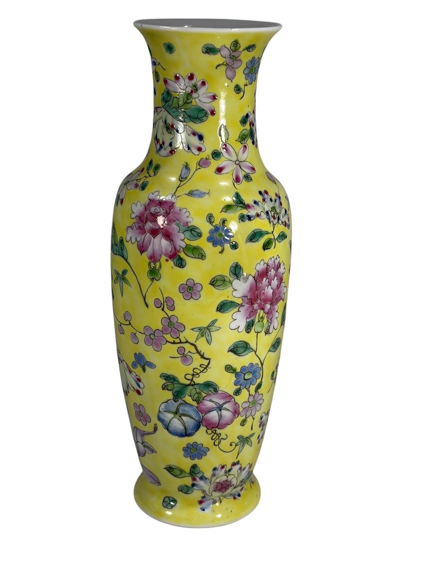 Chinese Famille Rose Style Porcelain Vase: Chinese Famille Rose style vase with polychrome florals on lemon-yellow ground. Flared rim, slender neck. Red four character mark on its base.Dimensions: 11 X 3.75 X 3.75 in. Condition: Good overall