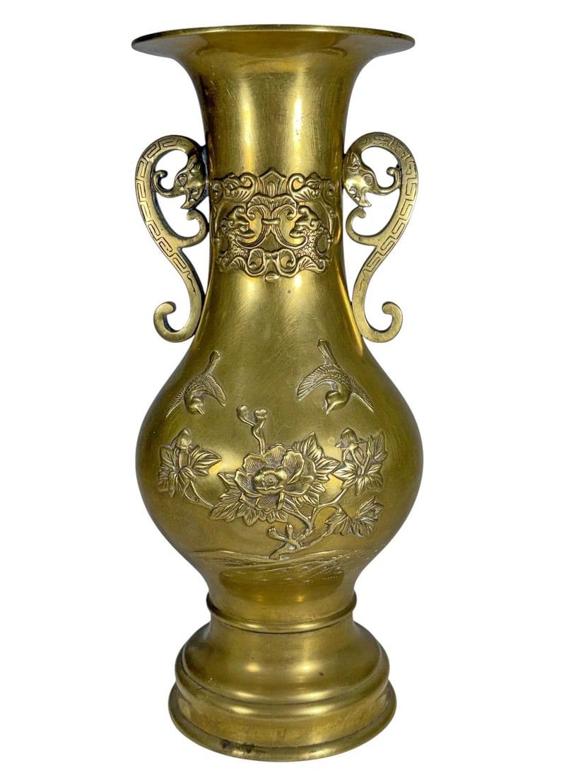 Vintage Chinese Elephants Handles Brass Vase: Vintage Chinese brass vase with baluster form, flared rim, and elephant head handles. Relief scrolling and floral panels with bird accents.Dimensions: 12.25 X 5 X 5 in. Condition: Good overall