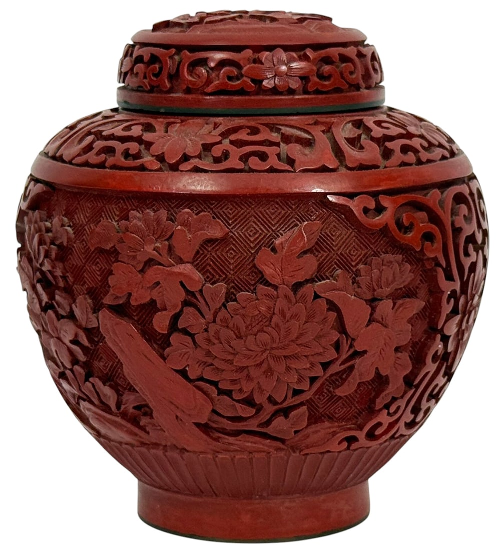 Chinese Cinnabar Carved Lacquer Lidded Ginger Jar: Chinese cinnabar lacquer ginger jar with lid, featuring intricate floral and foliate motifs in deep relief. The body is adorned with peonies and leafy branches against a cross-hatched background,