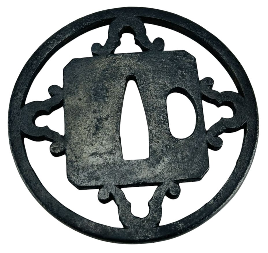 Traditional Japanese Forged Iron Tsuba Handguard: Disc shaped forged iron component mounted between the blade and the handle of a traditional style Japanese sword. Prevents the wielder's hand from sliding forwards on the sharp blade during strikes an