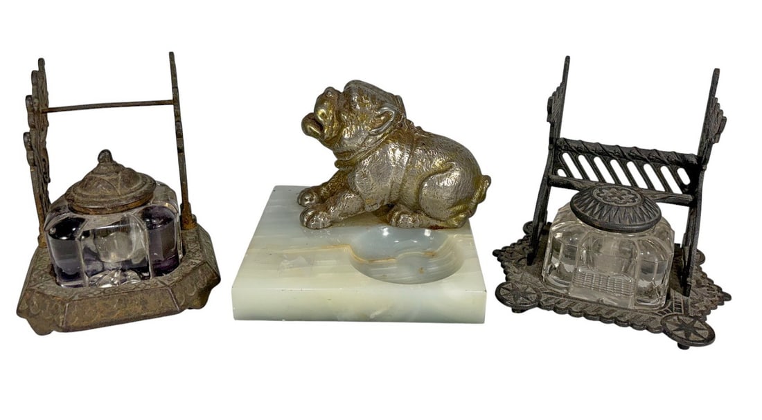 Iron & Glass Inkwells & Bronze Dog Ashtray 3pc LOT: Group of three antique-style desk accessories, including two cast iron and glass inkwells with ornate Victorian detailing, and a bronze bulldog ashtray mounted on an onyx base. The largest measures ap