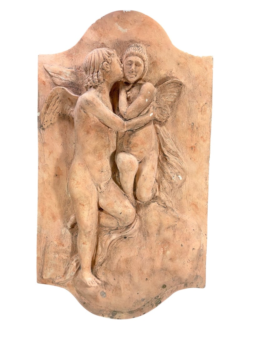 Vintage Nude Couple Plaster Wall Plaque: Vintage plaster wall plaque in high relief depicting two nude winged figures embracing. Terracotta toned patina on shaped rectangular backplate with contoured edges.Dimensions: 22.75 X 12.75 X 3 in.