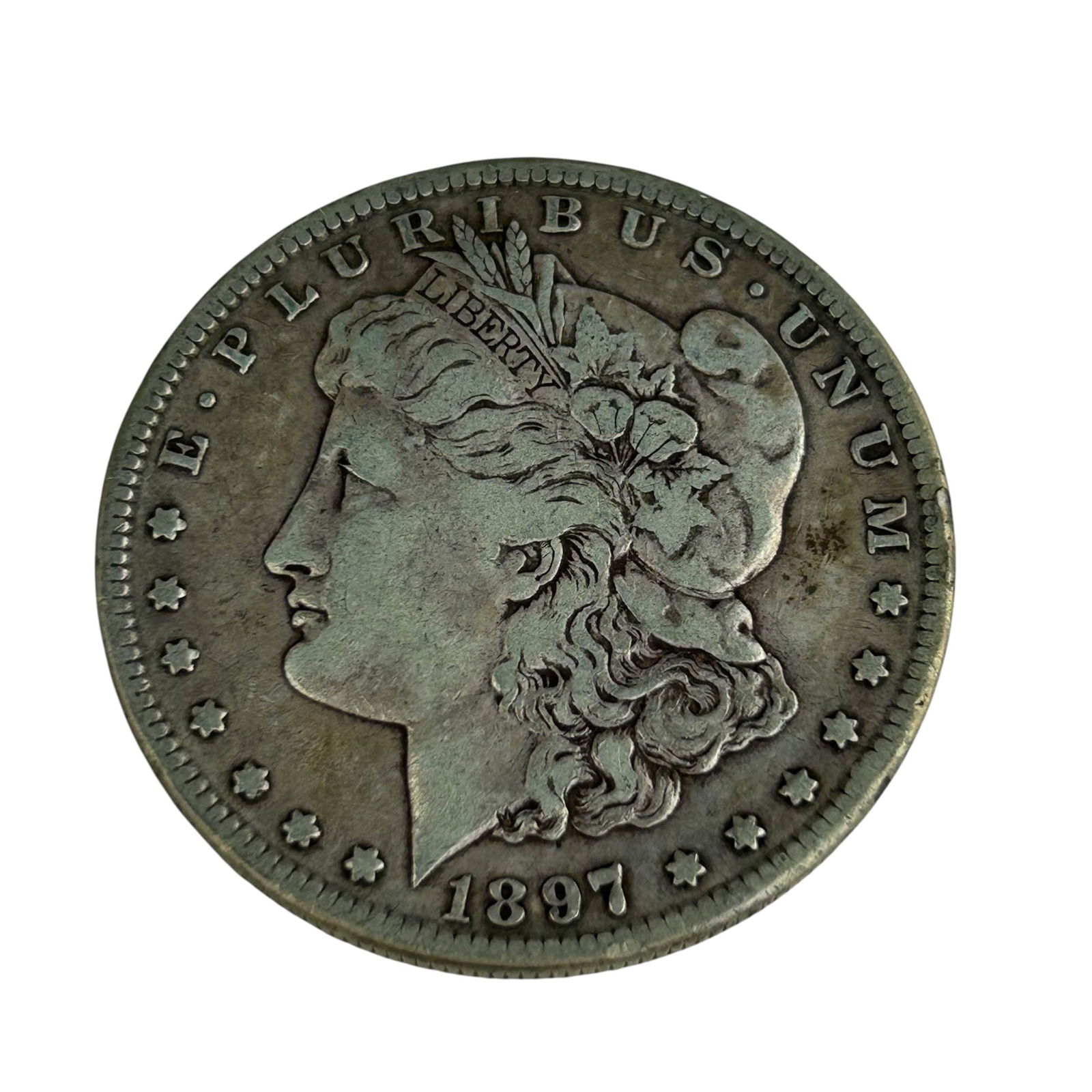 United States 1897 S Morgan Silver Dollar Coin: United States 1897 Morgan Silver Dollar struck in San Francisco. Designed by George T. Morgan, featuring a left facing Liberty on the obverse and a heraldic eagle on the reverse with the "S" mintmark