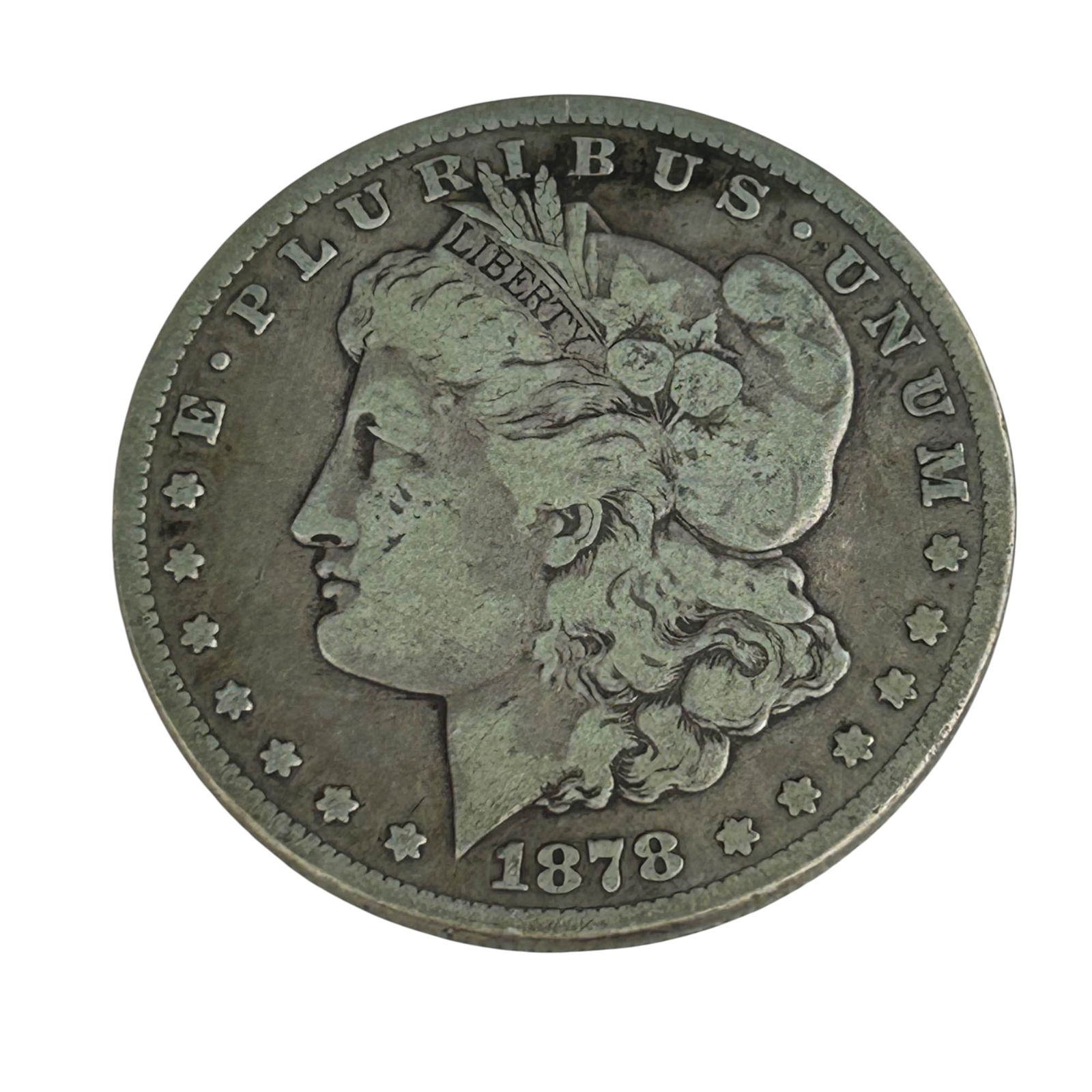 United States 1878 CC Morgan Silver Dollar Coin: United States 1878 Morgan Silver Dollar struck in Carson City. Designed by George T. Morgan, showing Liberty in profile on the obverse with the motto E Pluribus Unum, and a heraldic eagle on the rever