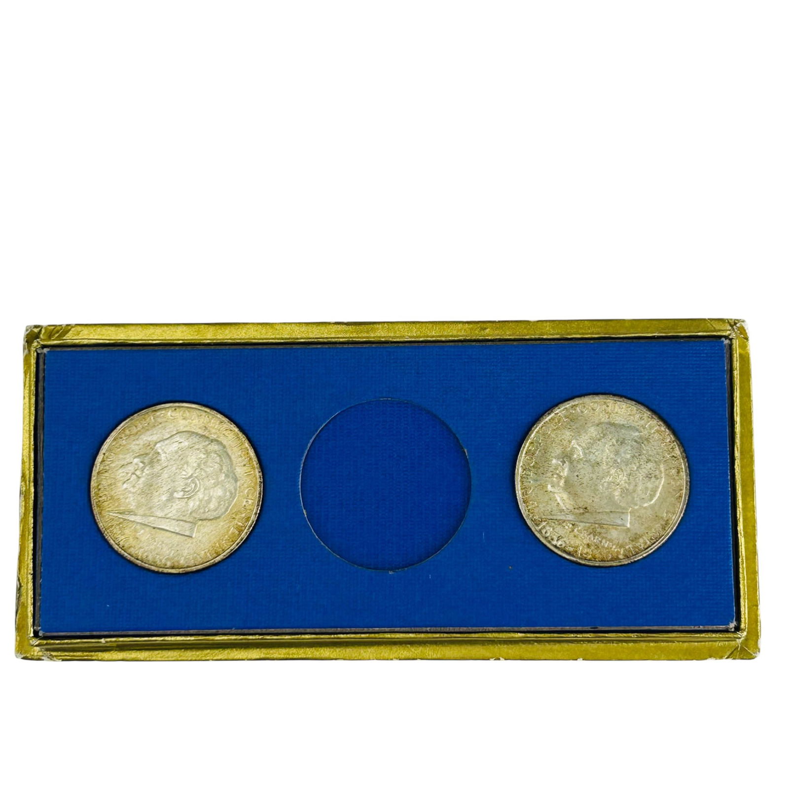 P T Barnum Pr 1836-1936 Half Dollar US Coins w Box: Two 1936 commemorative silver half dollars issued for Bridgeport, Connecticut Centennial. Obverse features Phineas Taylor Barnum. Reverse shows eagle above city skyline. Coins presented in a blue box.