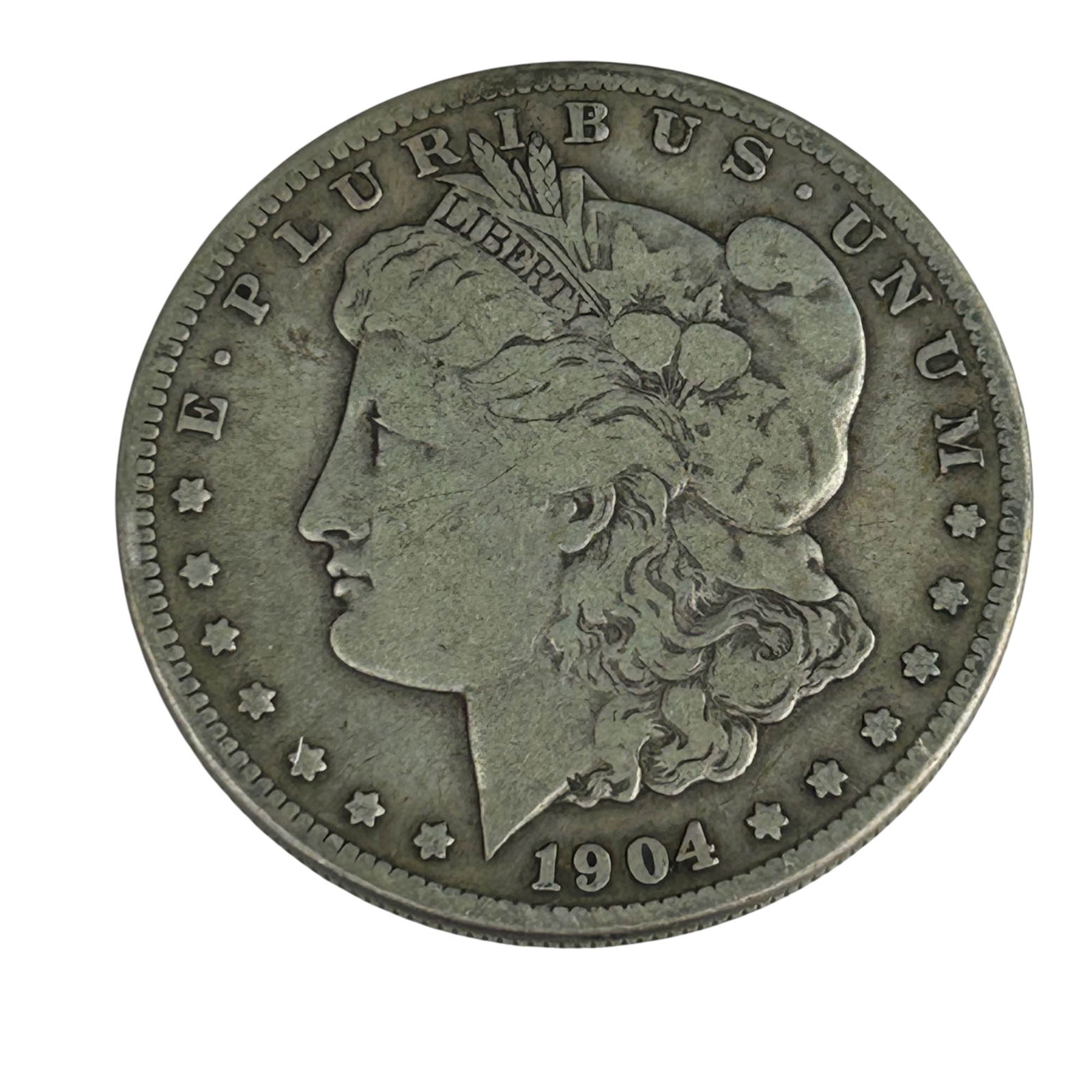 United States 1904 S Morgan Silver Dollar Coin: United States 1904 Morgan Silver Dollar struck in San Francisco. Designed by George T. Morgan, featuring Liberty in profile on the obverse and a heraldic eagle on the reverse. The "S" mintmark is loca