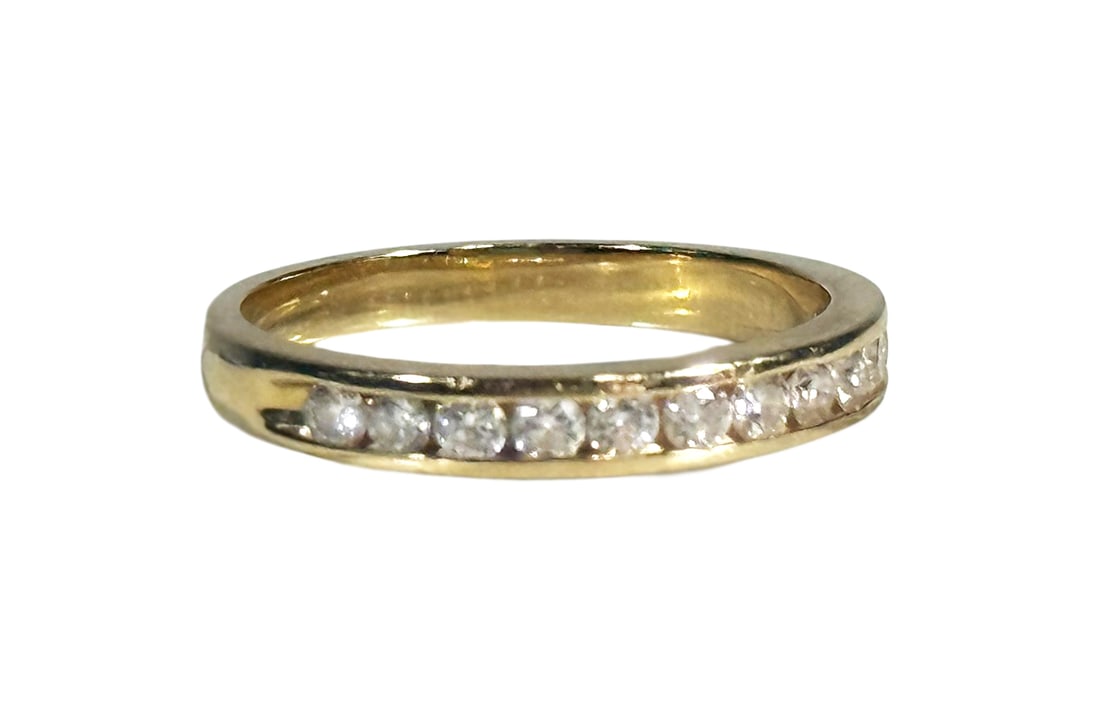 14K Yellow Gold Ladies Diamond Eternity Band Ring: Ladies wedding band is crafted in 14k yellow gold and features twelve round brilliant cut diamonds set in a classic channel setting. The diamonds have a total weight of approximately .5 cts and are gr