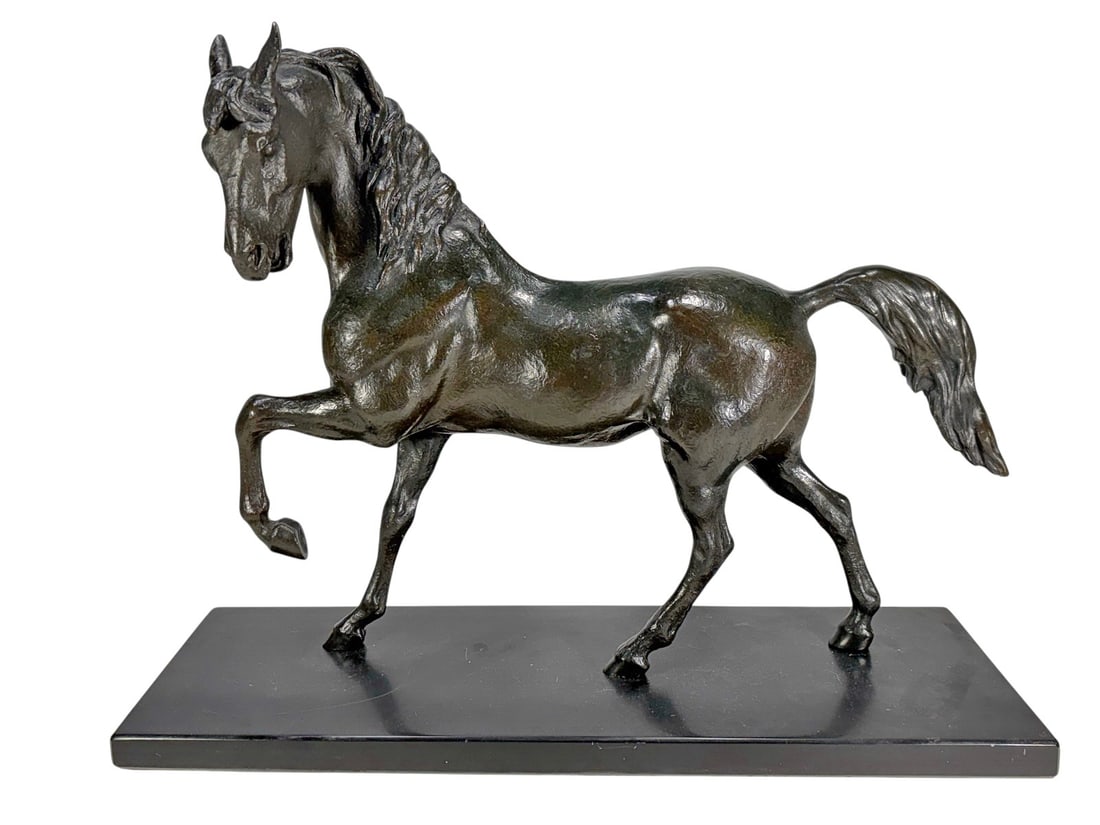 Austin Pro Claude Leclerc Design Bronze Sculpture: Cast bronze horse sculpture by Claude Leclerc for Austin Productions depicting a trotting horse mid stride with raised foreleg and flowing mane. Mounted on a black marble base.Dimensions: 15.5 X 19.5