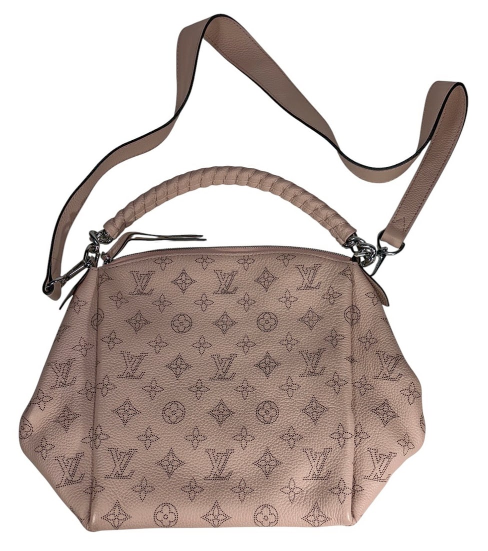 Louis Vuitton Style Mahina Babylone Monogram Bag: Louis Vuitton style Mahina Babylone handbag in blush pink perforated monogram leather with braided handle and removable strap. Silver tone hardware and zip top closure.Dimensions: 9 X 12.5 X 5 in. Con