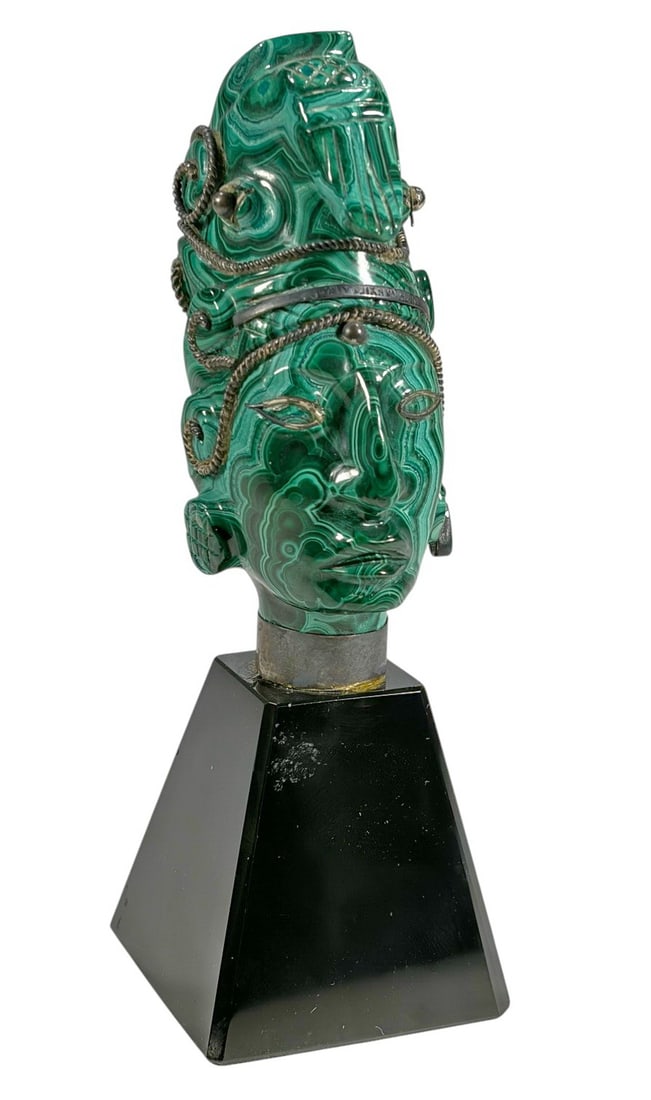 Aztec malachite, Onyx & Silver Head Sculpture: Aztec style head sculpture carved from green banded malachite with sterling silver wire accents and onyx inlay. Mounted on a black stone pyramid base.Dimensions: 5.75 X 1.75 X 1.75 in. Condition: