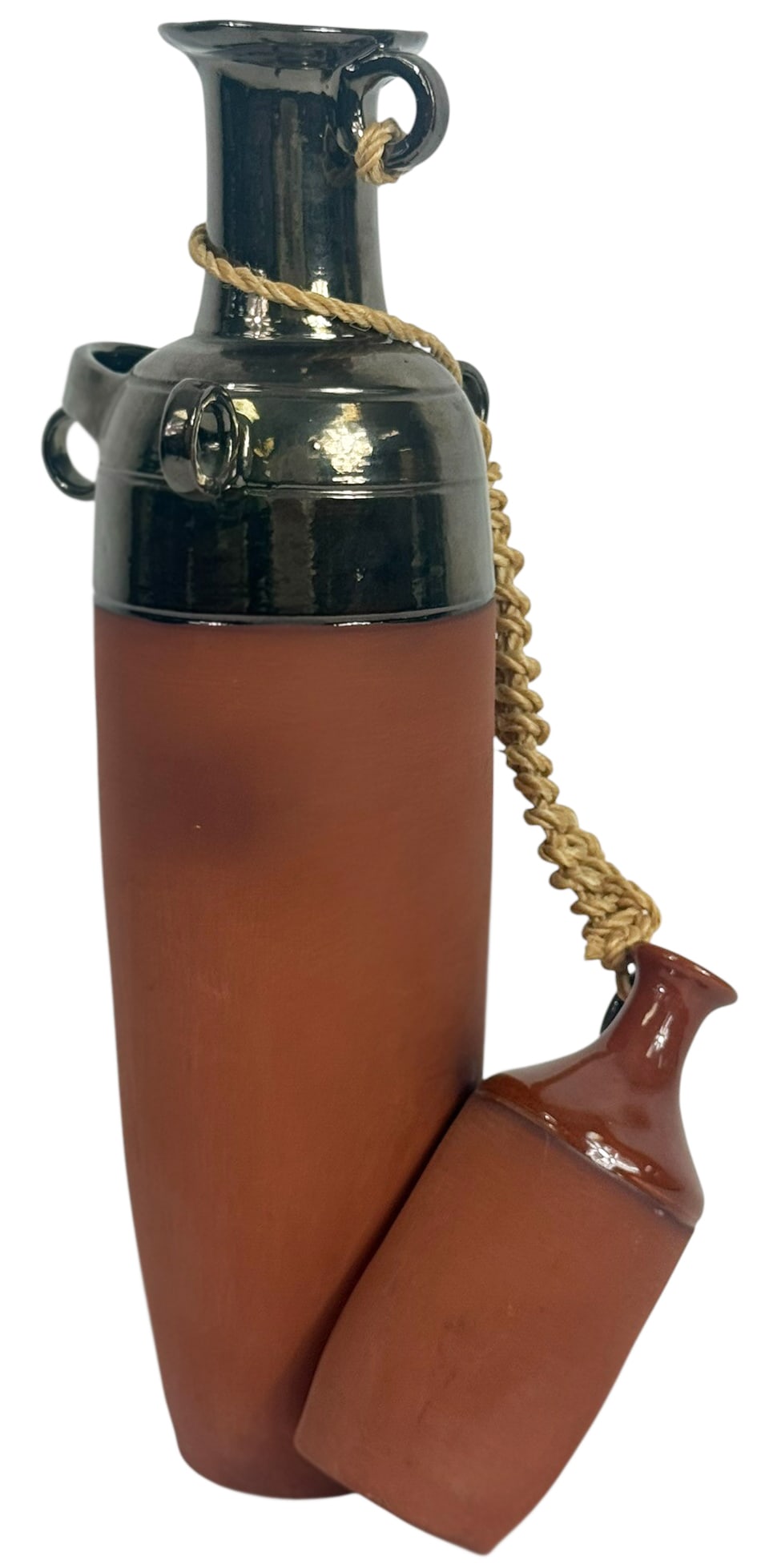 Eduardo Segovia Ceramic Pottery Vessel, 1994: Eduardo Segovia (Ecuadorian, 20th/21st century) sculptural ceramic vessel with the upper portion in a rich, dark glaze and the lower section left in raw terracotta. A secondary jug emerges from the