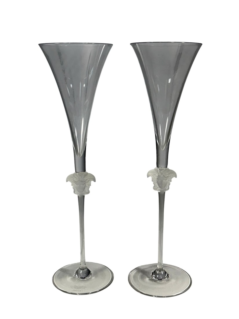 Versace by Rosenthal, Germany Medusa Glass 2pc LOT: Pair of Versace by Rosenthal Studio Line crystal champagne flutes, Germany, featuring frosted Medusa heads at the top of the stems and elongated tapered bowls. Acid-etched signature on its base: 'Rose