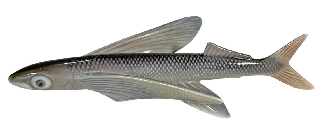 Royal Copenhagen Flying Fish Porcelain Figurine: Royal Copenhagen Denmark hand painted porcelain flying fish figurine with extended fins and textured body. Soft gray beige and white tones with glossy glaze. Underside is marked with the Royal Copenha