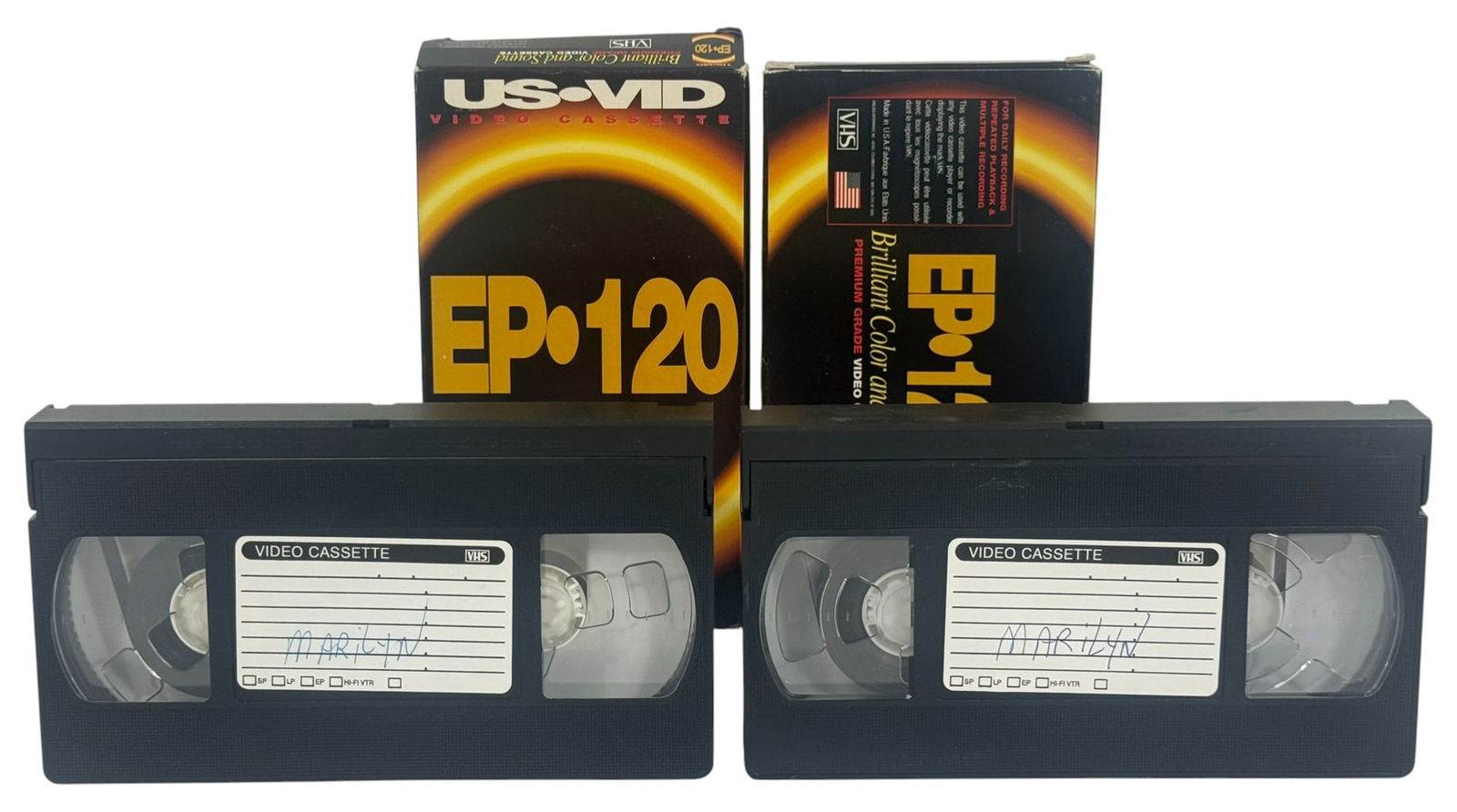 Pair of VHS Tapes - Marilyn Monroe Striptease 1949: Lot of two US-VID EP-120 VHS video cassettes labeled Marilyn. Includes original boxes and a typed note referencing an 11-minute, soundless black-and-white film featuring Marilyn Monroe, purportedly fr