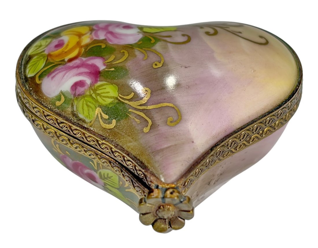 Limoges France Jewels of Carmel Heart Trinket Box: Limoges France Peint Main Jewels of Carmel porcelain heart form trinket box. Hand painted lid with pink and yellow roses, green leaves, and scrolling gilt accents on a blended mauve, cream, and olive