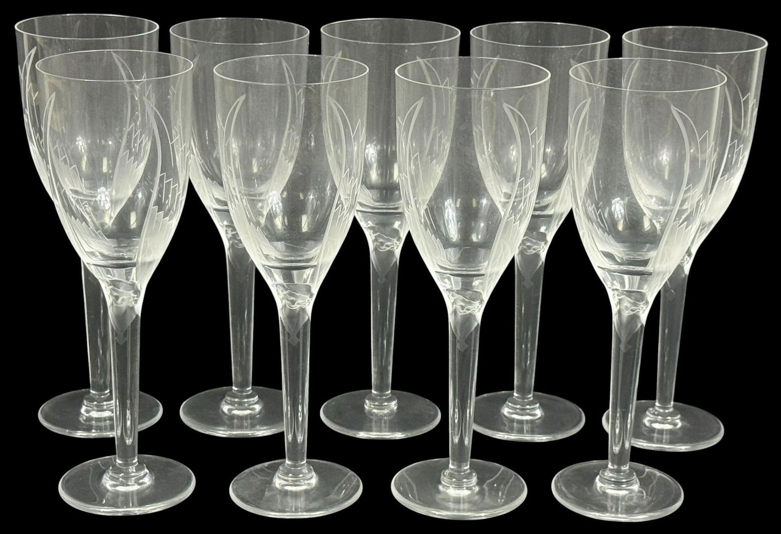 Lalique 'Angel' Crystal Champagne Flutes 8pc SET: Set of eight Lalique 'Angel' crystal champagne flutes, featuring finely etched angelic wing motifs rising from a delicately sculpted female figure at the base of each bowl. Each measures approximately