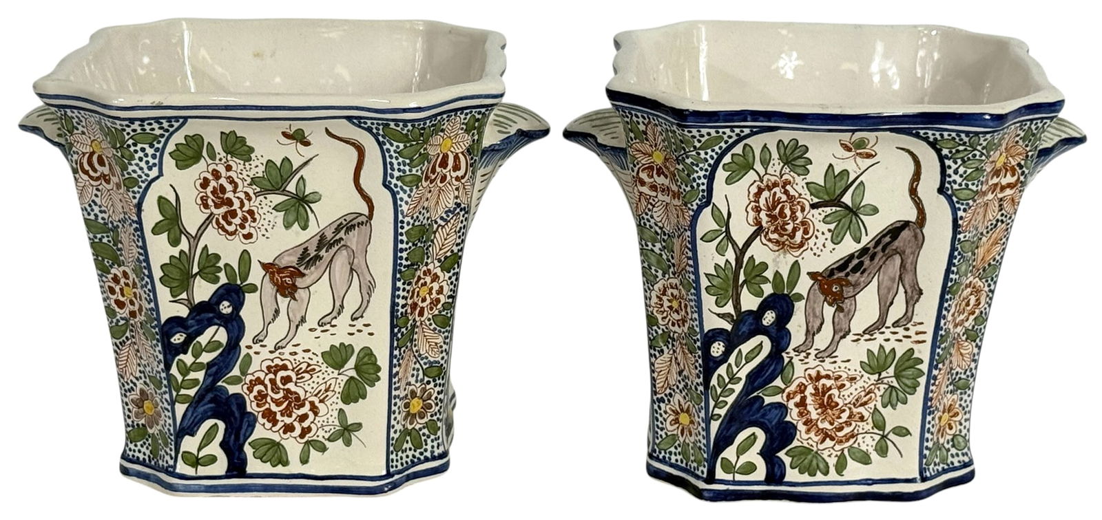 Pr of Tiffany & Co Ceramic French Faience Planters: Pair of Tiffany & Co. hand-painted French porcelain planters. The pair features a scalloped rim and flared form with integral handles, decorated in a vibrant palette with floral motifs, stylized urns,