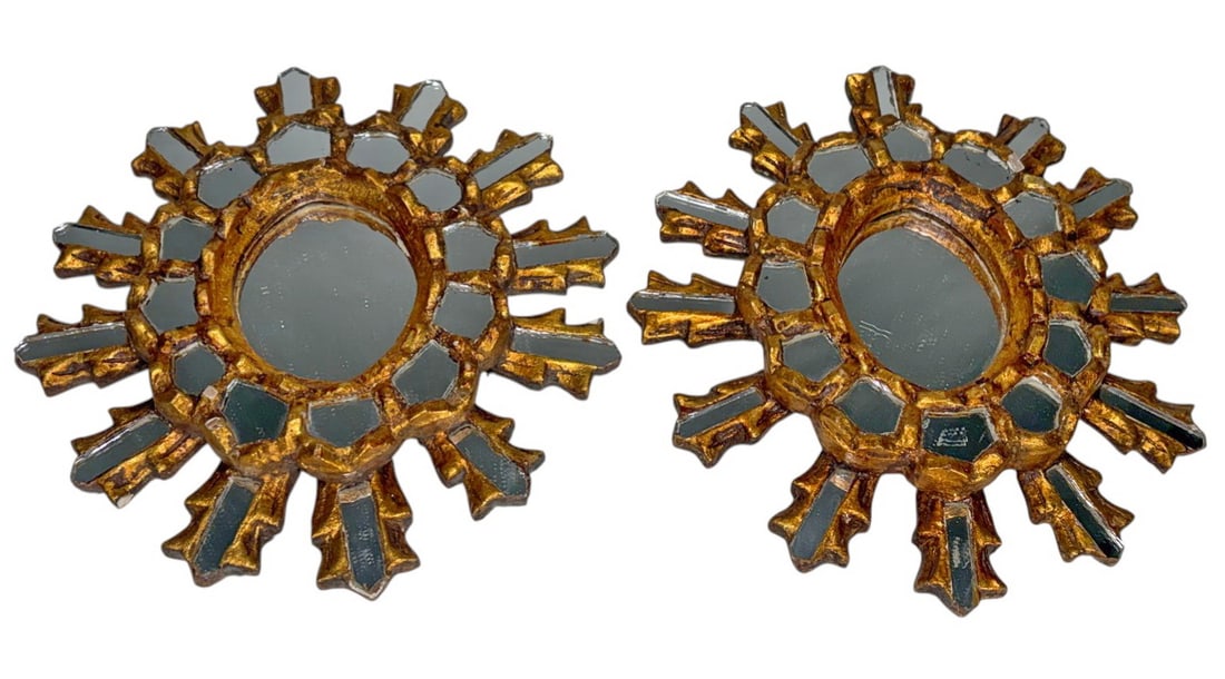 Pair of Italian Small Giltwood Sun Wall Mirrors: Pair of Italian giltwood sunburst wall mirrors with carved radiating rays and inset mirrored panels surrounding central round plates. Gilt finish, retaining original backing and hanging hardware.