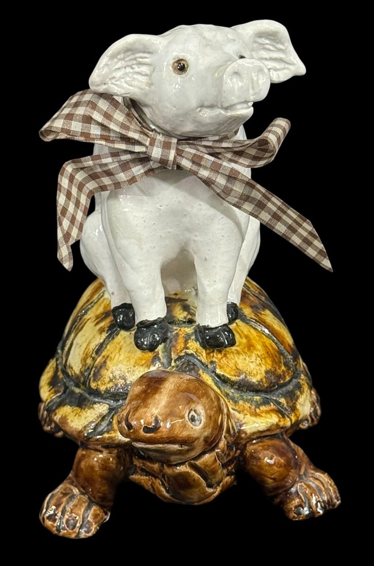 Majolica Ceramic Pig Riding a Turtle 9 Figure: Majolica-style glazed ceramic sculpture depicting a white pig with a gingham ribbon seated atop a brown and yellow turtle, both with expressive faces. Folk-art inspired, storybook quality decorative c