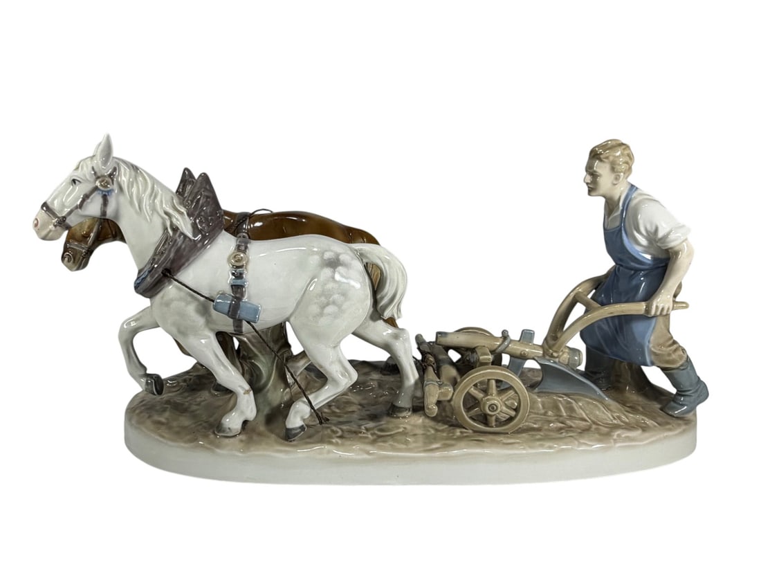 Carl Scheidig Kumst Porzellan German Farmer Fig: Carl Scheidig Kunst Porzellan German figural group depicting a farmer guiding a two horse plow. Finely modeled glazed porcelain with detailed harness and plow on a textured ground base. Underside with