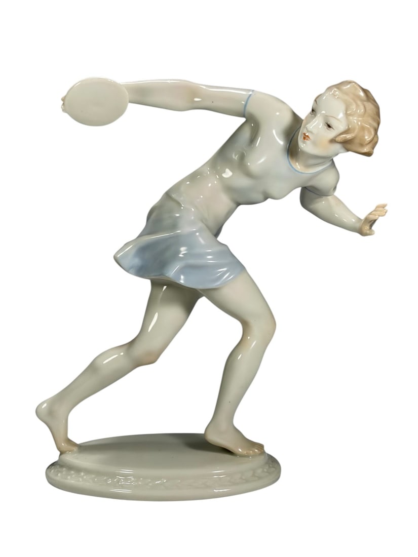 Hutschenreuther Girl Discus Thrower by Karl Tutter: Hutschenreuther Selb Girl Discus Thrower porcelain figurine designed by Karl Tutter. Youthful female athlete in dynamic stance holding a discus, wearing a pale blue athletic outfit with finely painted