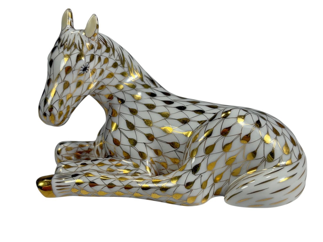 Herend Hungary Fishnet Foal Porcelain Gold Fig: Herend Hungary hand painted porcelain reclining foal figurine with fishnet pattern in black and gilt, with gilt accents to mane, tail, and hooves. Marked 'Herend Hungary' with Handpainted designation