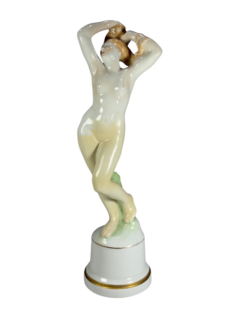 Herend Hungary Art Deco Nude by Gyorgy Nemes Fig: Herend Hungary porcelain nude figure, Art Deco style, designed by Gyorgy Nemes. Standing female nude with arms raised behind head and ankles crossed, ivory glaze with light shading, on cylindrical whi