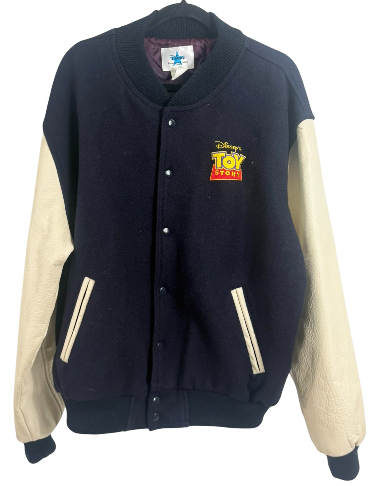 Disney Toy Story Promotional Varsity XL Jacket: Disney Promotional Products varsity-style jacket featuring an embroidered Toy Story patch on the chest. This limited-issue jacket has a classic two-tone design with navy wool body and genuine cream le