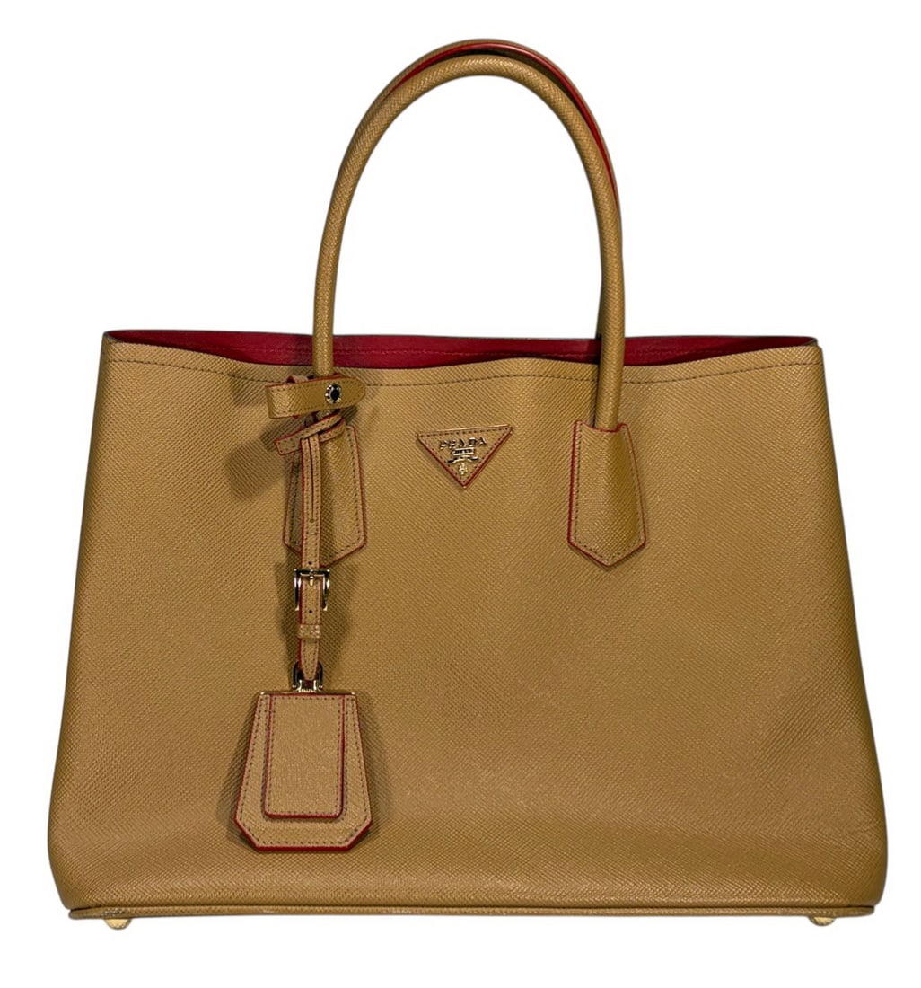 Prada Saffiano Cuir Style Leather Shoulder Bag: Prada Saffiano Cuir style camel cross grain leather tote bag with red interior and red edge glazing, dual rolled handles, gold tone hardware, triangular logo plaque, red leather lined interior,