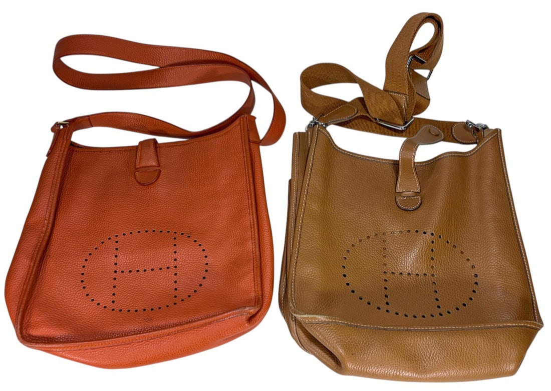 Hermes Evelyne Style Leather Shoulder Bag 2pc LOT: Pair of Hermes Evelyne style leather shoulder bags in orange and tan brown leather with perforated 'H' logos and adjustable straps. Both with leather strap and snap closure, tan with canvas strap and