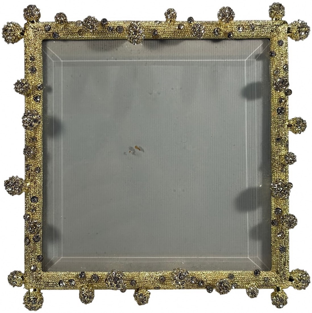 Olivia Riegel Gold Pave Odyssey Orb Picture Frame: Olivia Riegel Gold Pave Odyssey pattern picture frame with textured gold tone surface set with clear crystals and orb finials with clustered crystal spheres. Beveled front glass. Taupe fabric easel ba