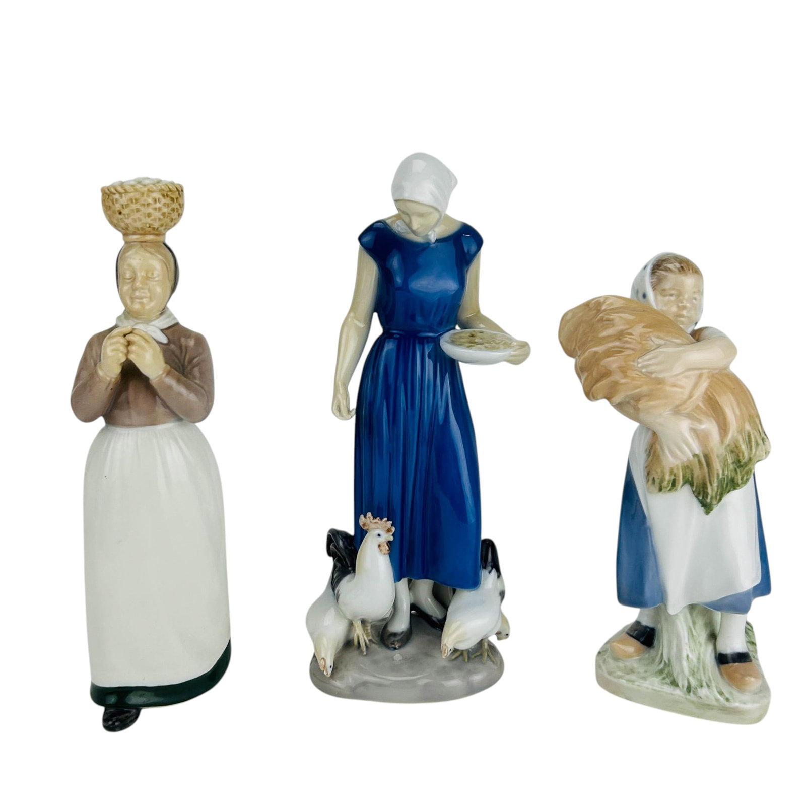 Royal Copenhagen Bing & Grondahl Figurines 3pc LOT: Lot of three Scandinavian hand painted Danish porcelain rural genre figurines. Includes a Royal Copenhagen Girl with Neg #908 (Girl holding a Corn Sheaf), and two Bing and Grondahl figurines that incl