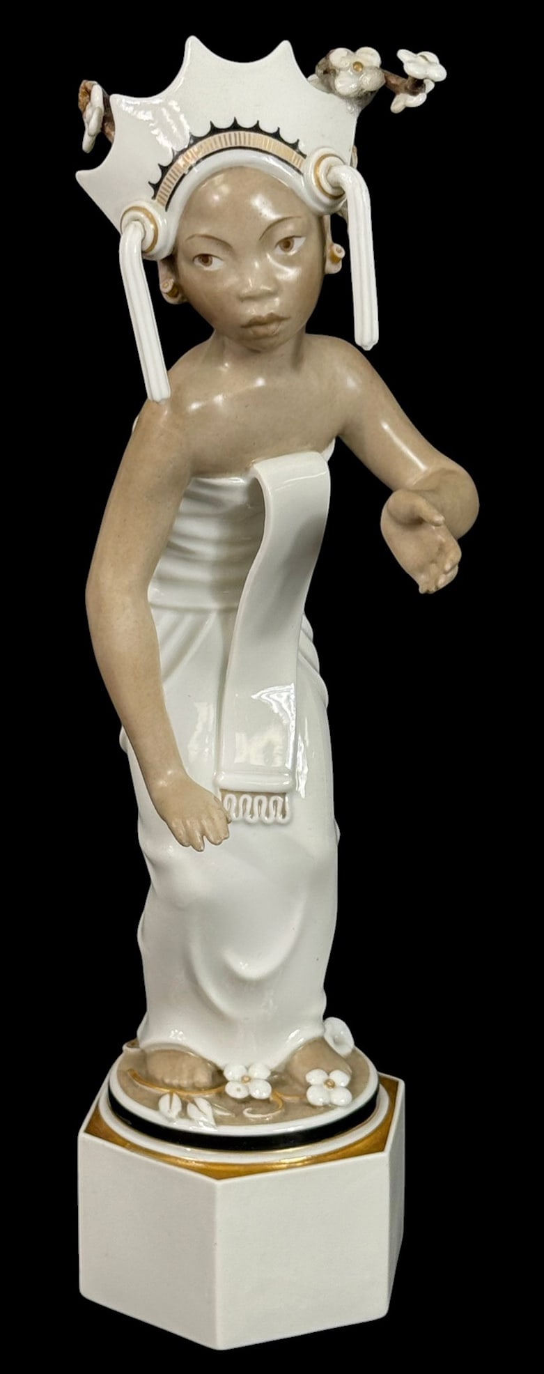 Royal Copenhagen Balinese Dancer Porcelain Figure: Royal Copenhagen hand-painted porcelain figurine titled "Balinese Dancer." This piece features a young dancer in traditional Balinese costume, adorned with floral details and a stylized headdress. Sta