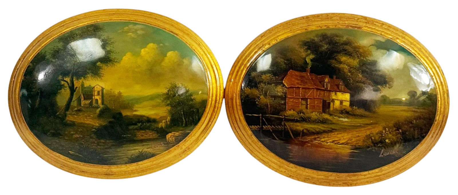Pair Oval Framed European Landscape Wall Plaques: Pair of oval landscape wall plaques depicting pastoral European scenes including a country cottage by a stream and a chapel along a rural path executed in the style after Maurice Levis (French, 1860 -