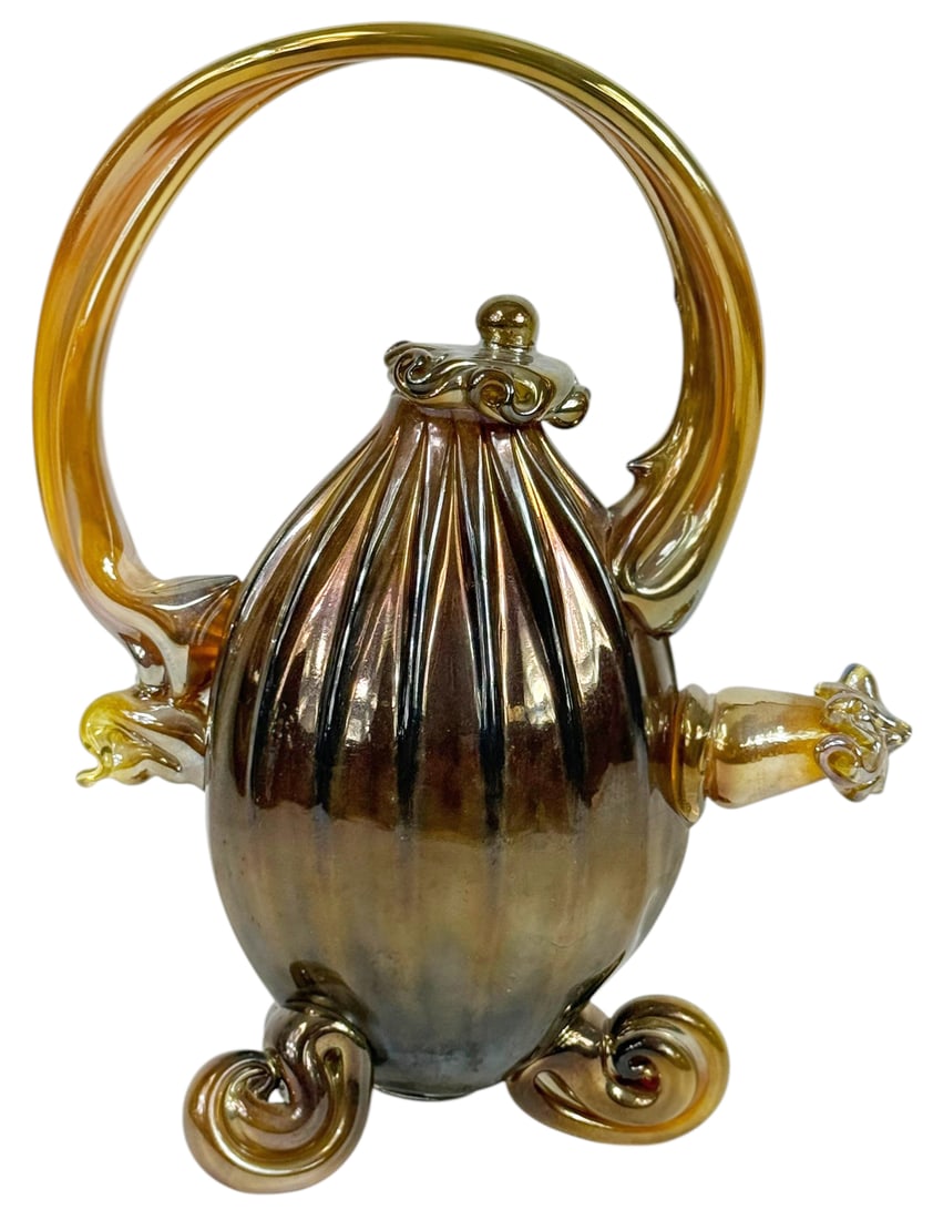 Paul Allen Counts Blown Art Glass Teapot Sculpture: Paul Allen Counts (American, born 1955) hand-blown glass teapot sculpture featuring a ribbed, bulbous body with an iridescent bronze and amber finish, elegantly accented by a dramatic looping handle,