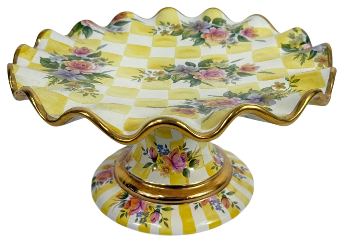 MacKenzie-Childs Honeymoon Lemon Curd Cake Stand: MacKenzie-Childs vibrant hand-painted ceramic pedestal cake stand, crafted in the "Honeymoon Lemon Curd" pattern. The ruffled edge and top surface are adorned with yellow and white checkerboard square