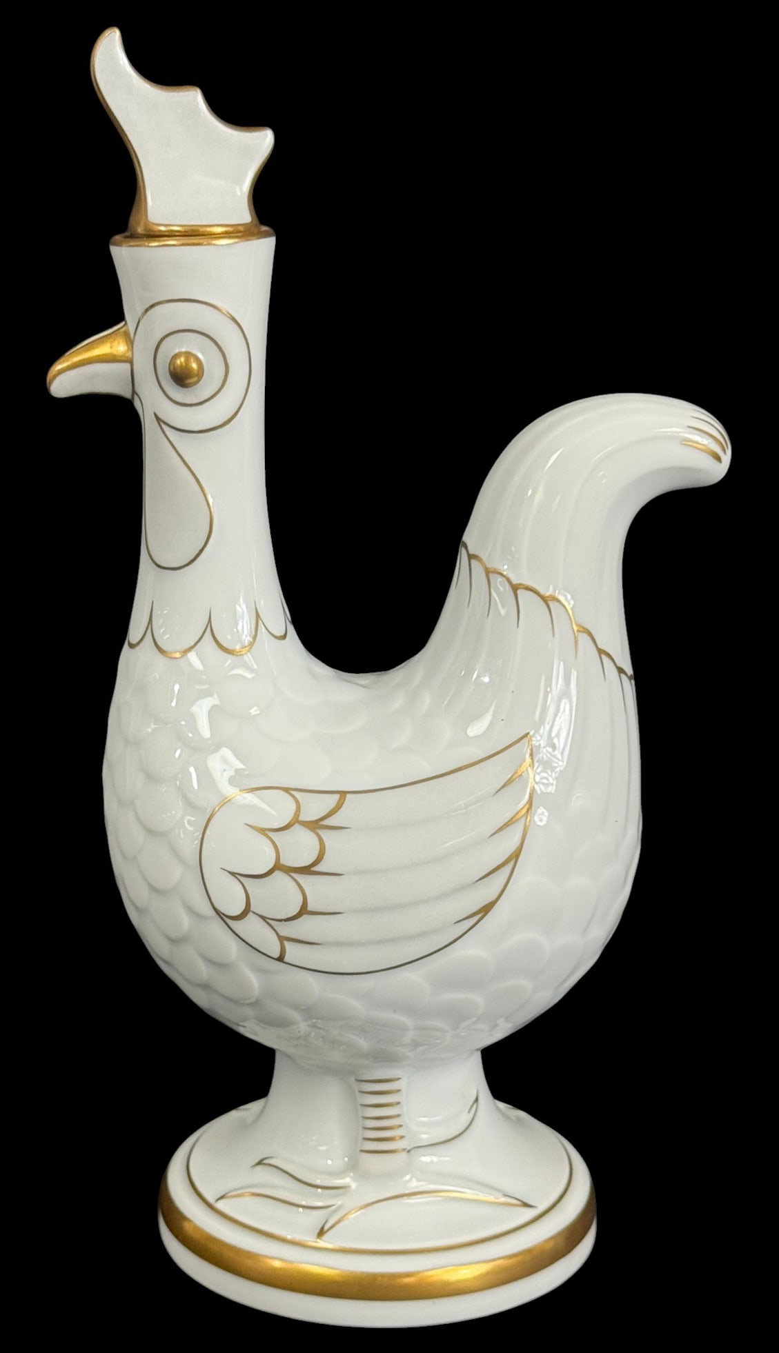 Bing & Grondahl Gilt Porcelain Rooster Jug 11" H: Bing & Grondahl Danish white porcelain figural jug in the shape of a stylized rooster. The sculptural form is detailed with embossed feathers and accented throughout with hand-painted gilt highlights,