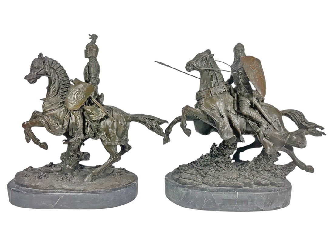 Pair of Knight on Horse Bronze & Marble Sculptures: Pair of bronze tone sculptures depicting medieval knights on rearing horses with shields and weapons, with detailed armor and caparisoned horses. Each mounted on an oval gray marble base with