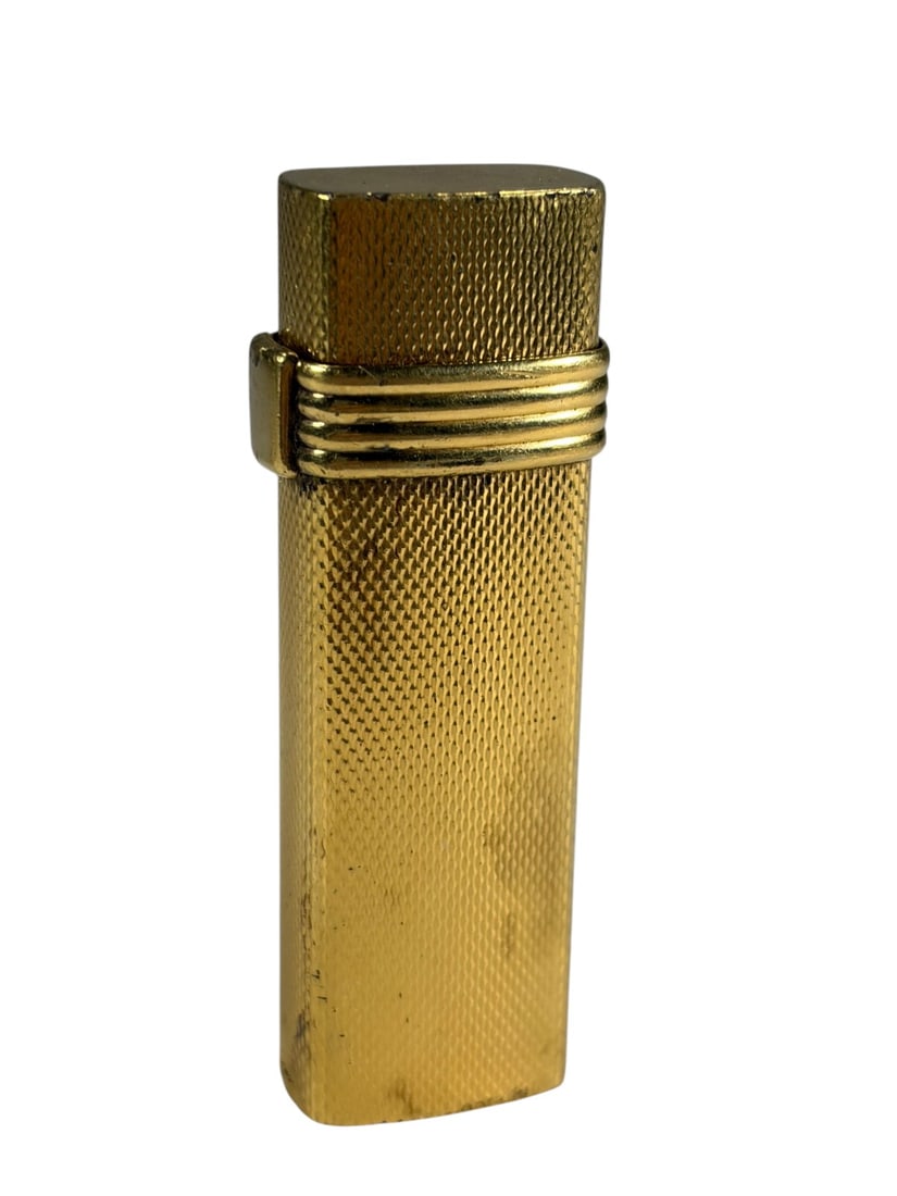 VTG Christian Dior Paris Gold Plated Lighter: Christian Dior Paris gold plated lighter with textured engine turned finish and ribbed band detail. Slim rectangular form with hinged lid and flint wheel ignition. Marked 'Christian Dior Paris.'Dimens