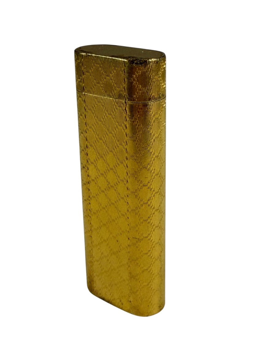VTG Cartier Paris 18K Gold Plated Luxury Lighter: Cartier Paris gold plated lighter in elongated rectangular form with textured pattern. Hinged lid and flint wheel ignition. Base is stamped 'Cartier Paris, serial 7429887, Swiss Made.'Dimensions: 2.75